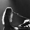 my profile on stage, backlit with hair covering my face